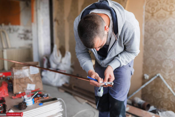 Plumber working on a new pipe installation